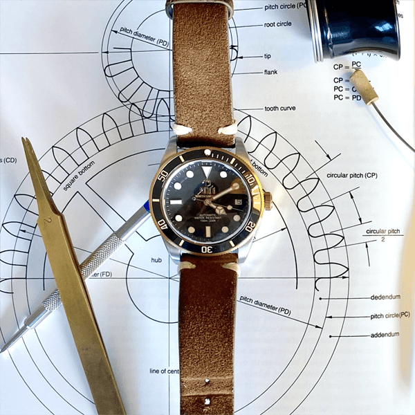 An Ali’i watch sits on a diagram of a watch wheel
